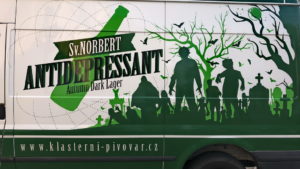 A lush green valley with a river flowing through mountainous terrain under a cloudy sky.