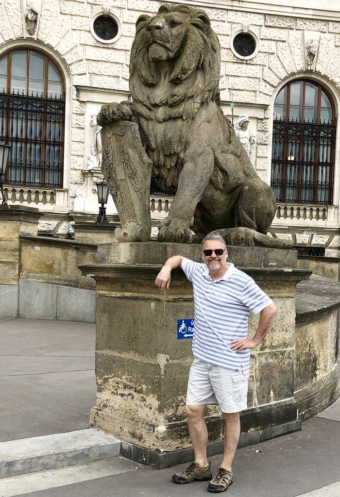 A lush green valley with a river flowing through mountainous terrain under a cloudy sky.