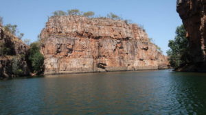 Passengers relaxing in a train's lounge car with drinks and casual seating.