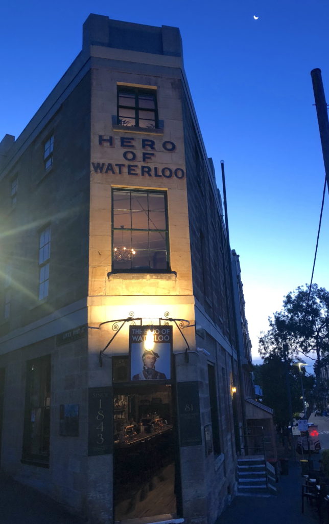 Historic Hero of Waterloo building illuminated at dusk.