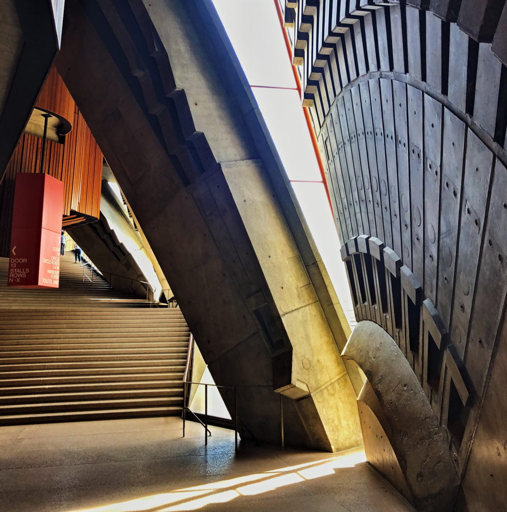 Modern architectural interior with curved walls and dramatic lighting.