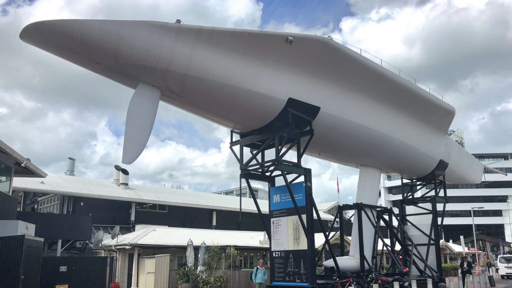 A large white blimp tethered with support structures outdoors.