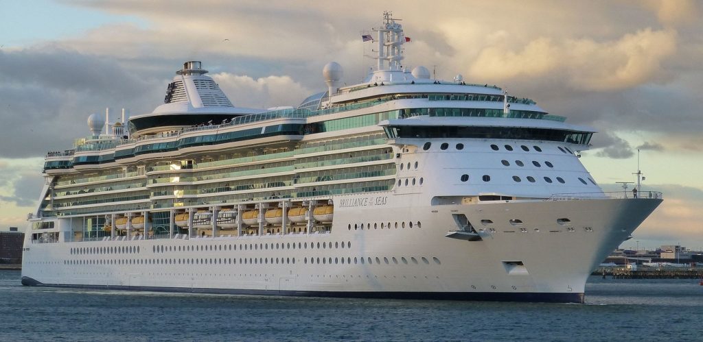 A lush green valley with a river flowing through mountainous terrain under a cloudy sky.