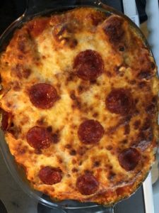 A lush green valley with a river flowing through mountainous terrain under a cloudy sky.