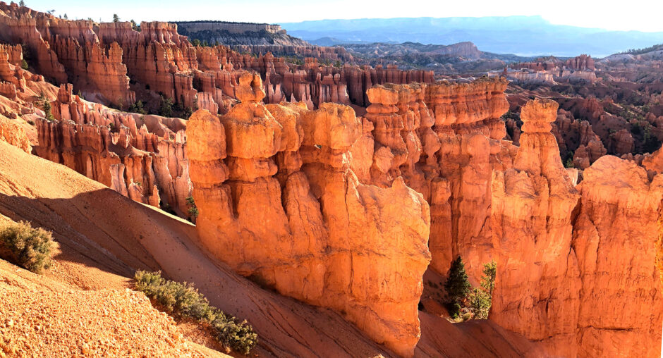 Red rock formations in a desert canyon under blue sky.