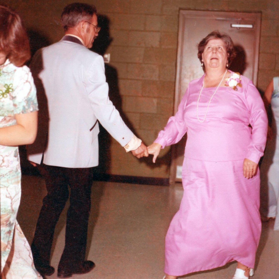 A lush green valley with a river flowing through mountainous terrain under a cloudy sky.