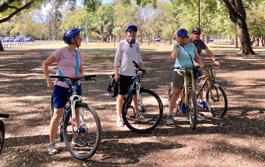 A lush green valley with a river flowing through mountainous terrain under a cloudy sky.