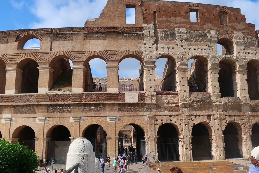 A lush green valley with a river flowing through mountainous terrain under a cloudy sky.