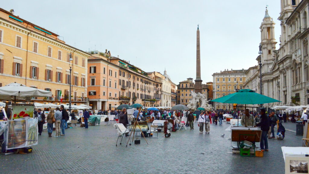 A lush green valley with a river flowing through mountainous terrain under a cloudy sky.