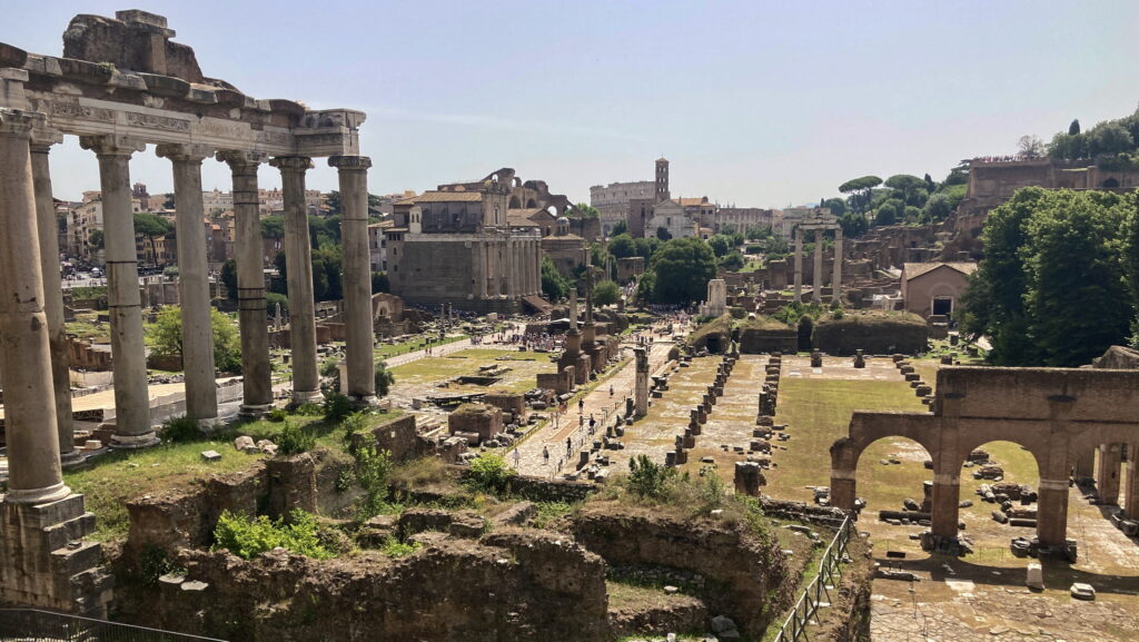 A lush green valley with a river flowing through mountainous terrain under a cloudy sky.