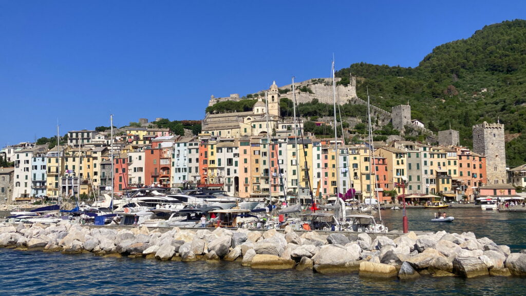 A lush green valley with a river flowing through mountainous terrain under a cloudy sky.
