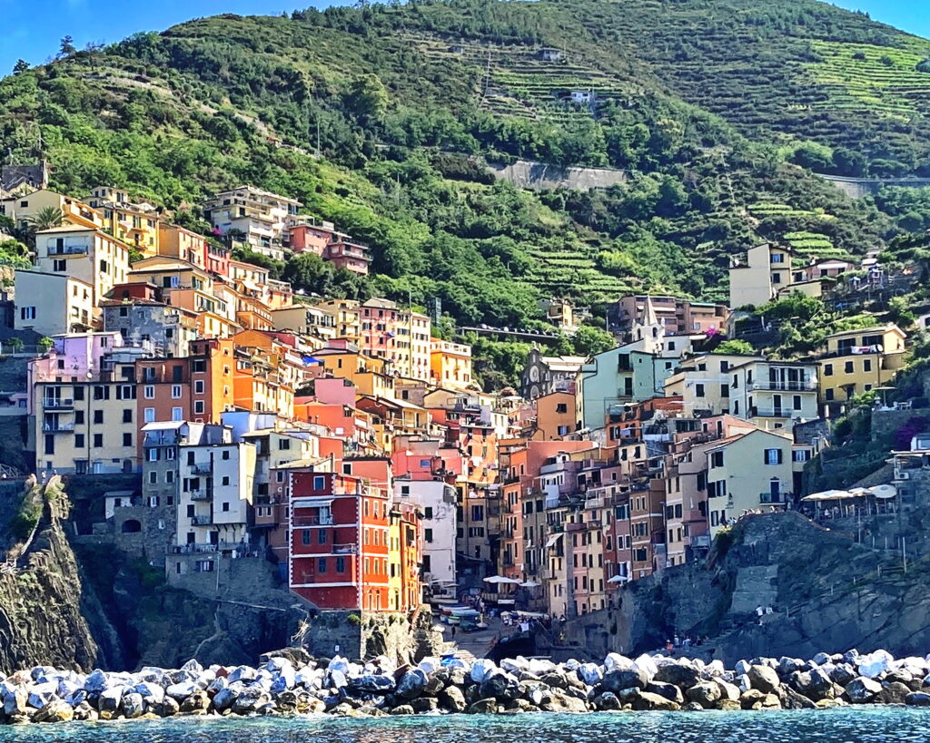 A lush green valley with a river flowing through mountainous terrain under a cloudy sky.
