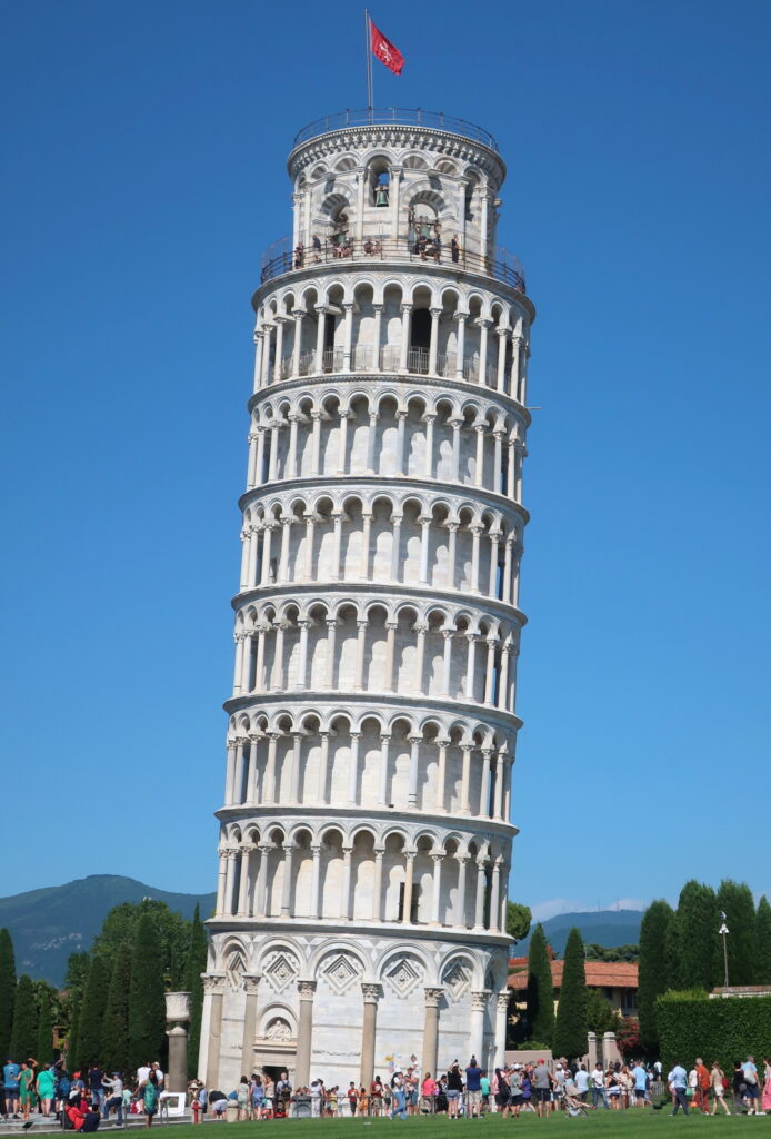 A lush green valley with a river flowing through mountainous terrain under a cloudy sky.