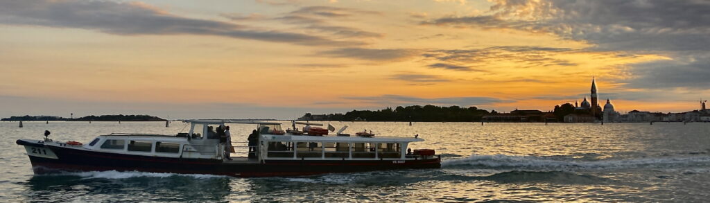 A lush green valley with a river flowing through mountainous terrain under a cloudy sky.