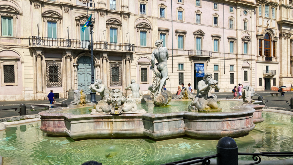 A lush green valley with a river flowing through mountainous terrain under a cloudy sky.