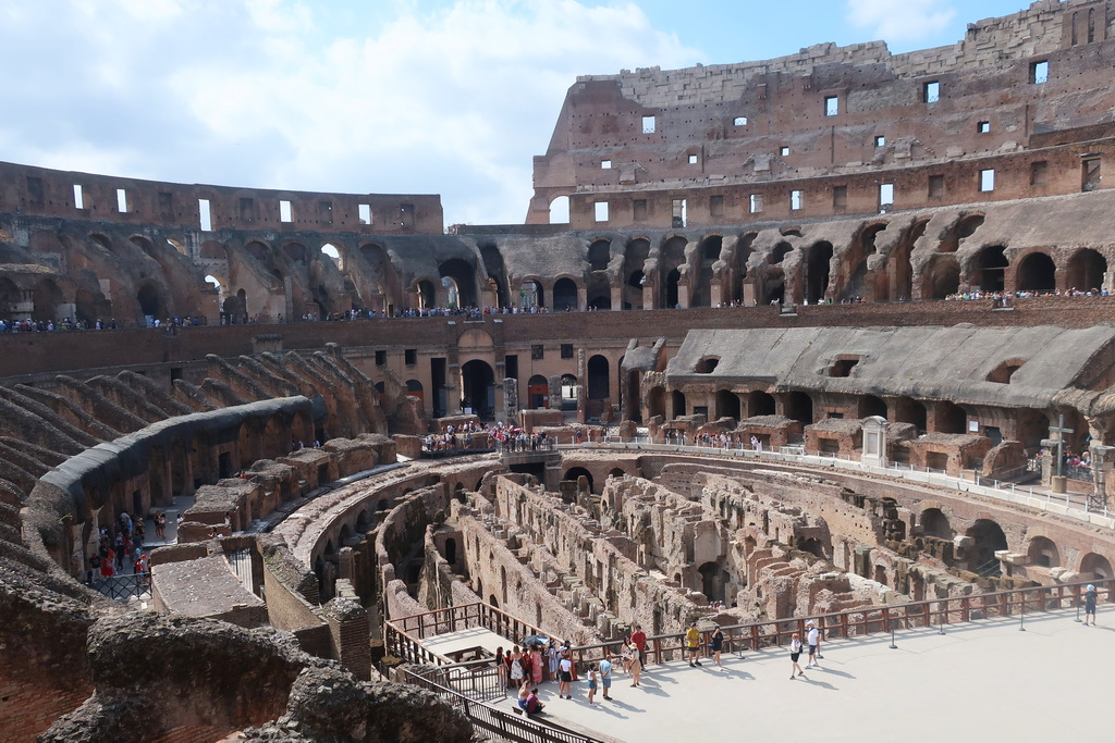 A lush green valley with a river flowing through mountainous terrain under a cloudy sky.