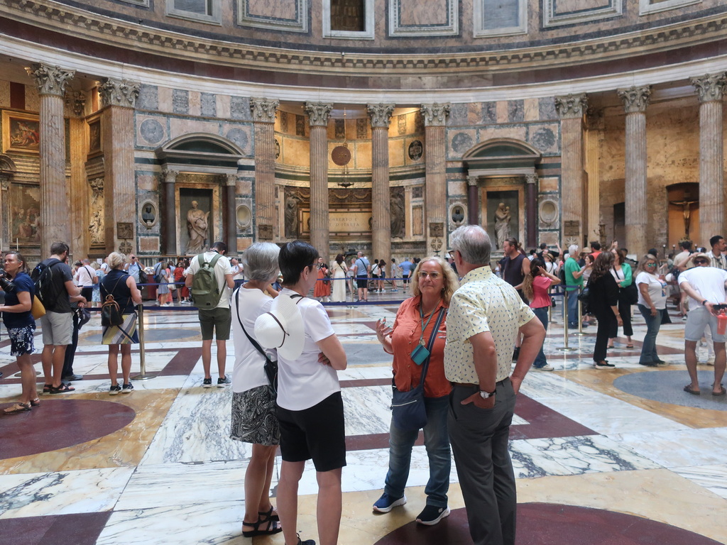 A lush green valley with a river flowing through mountainous terrain under a cloudy sky.